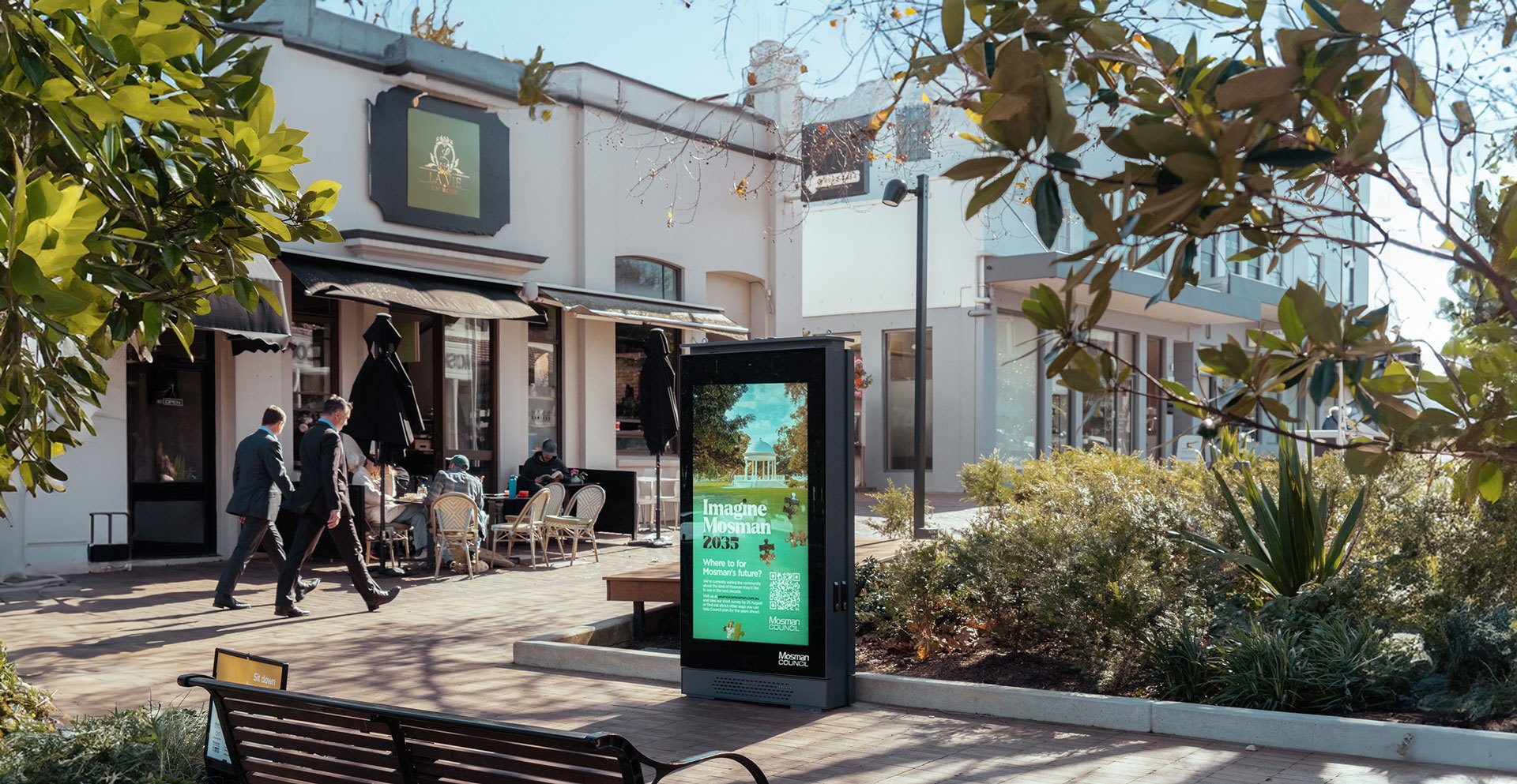 An outdoor TINNOX digital kiosk on a shopping street