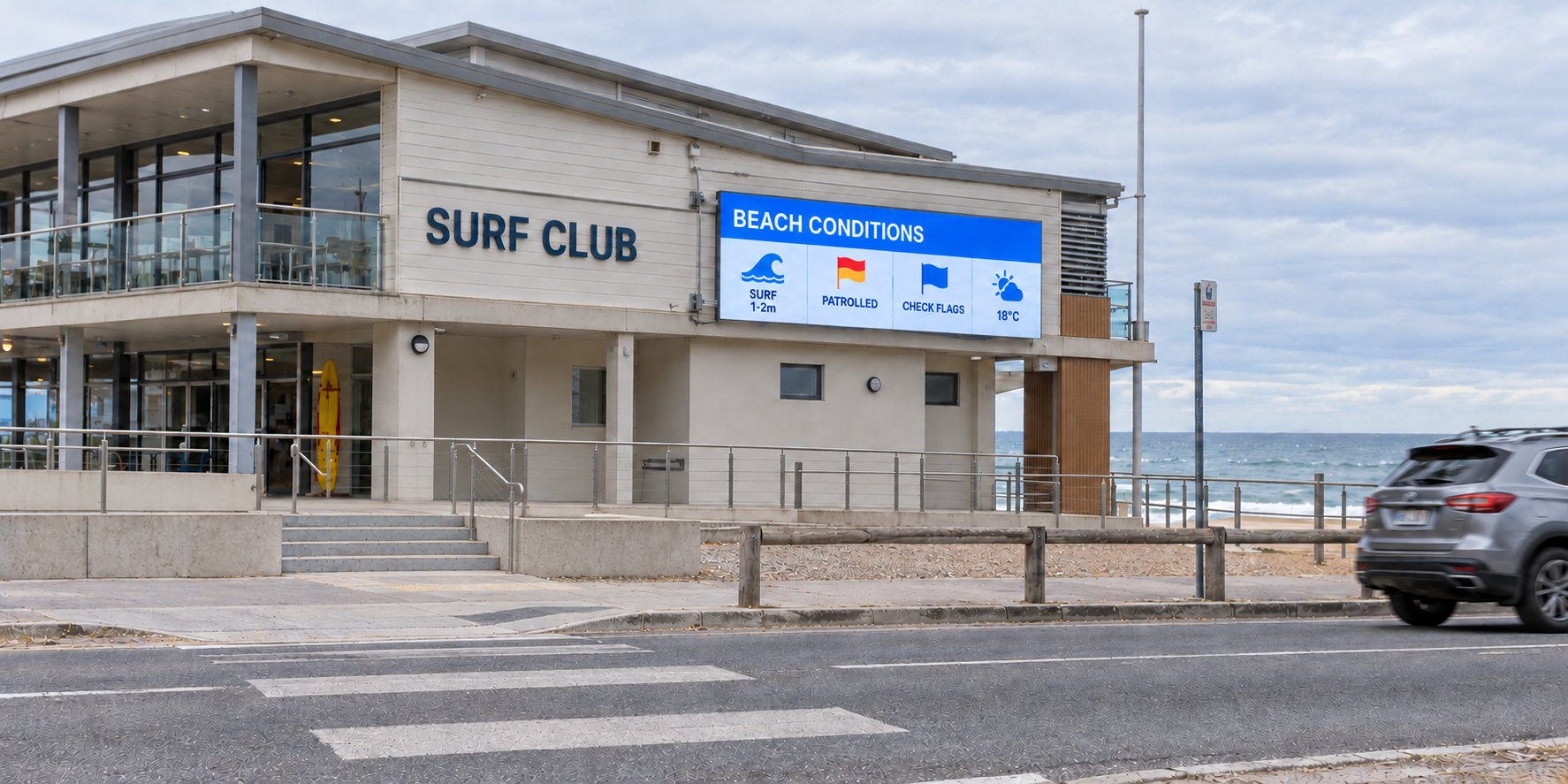 A DuraBlaze electronic sign showing beach conditions on the façade of a coastal surf club