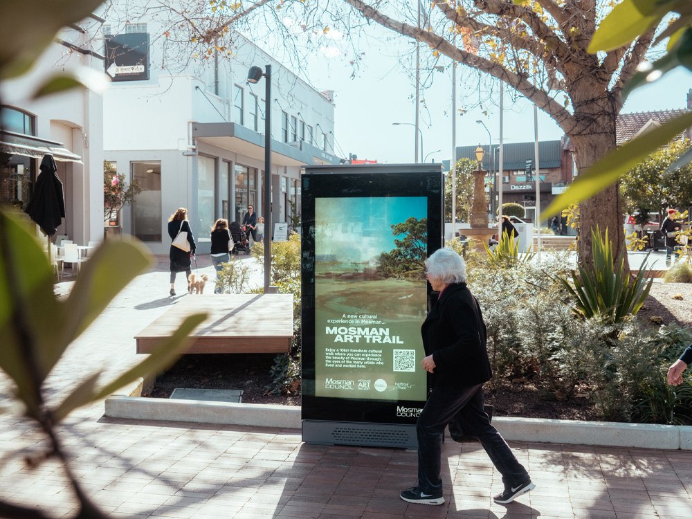 A digital kiosk in a plaza showing the Mosman Art Trail
