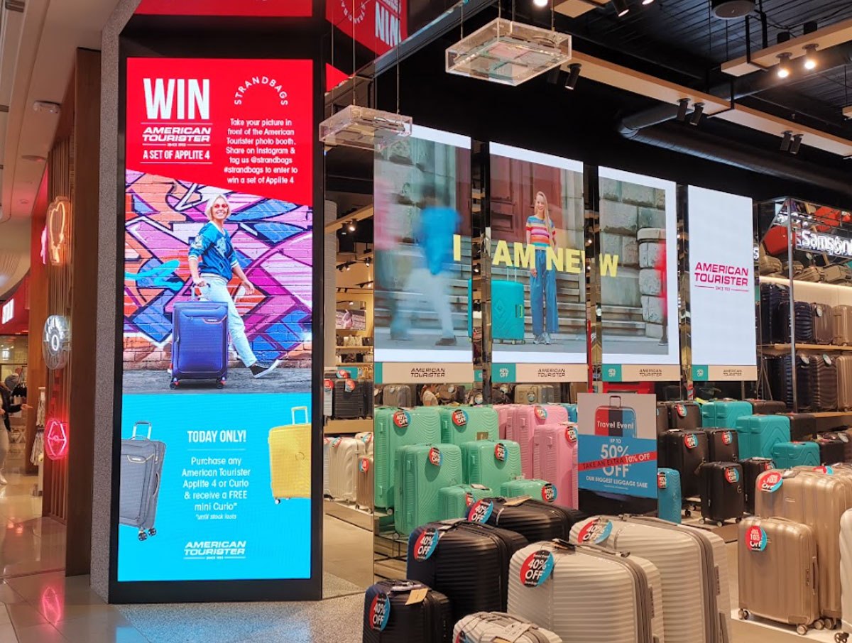LED displays running a campaign across an American Tourister store
